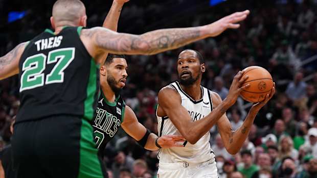 Brooklyn Nets forward Kevin Durant (7) looks to pass against Boston Celtics forward Jayson Tatum.